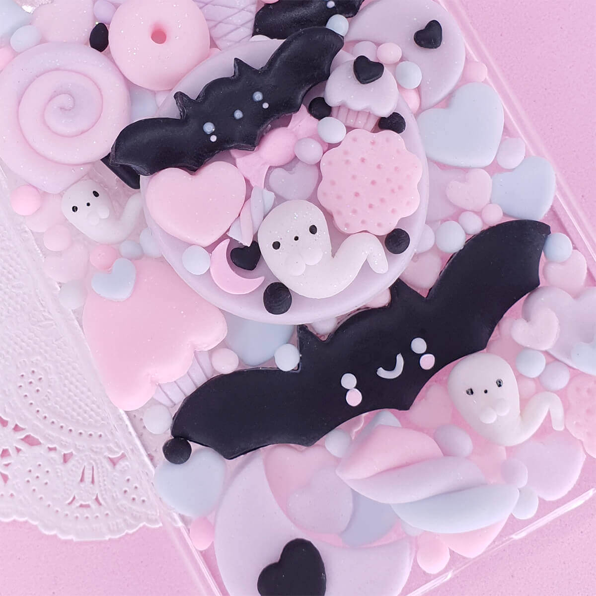 Handmade Pastel Goth Decoden case with black bats and pink ghosts on lavender 3D charms case, available for iPhone, Samsung, Oppo, and all smartphone models.