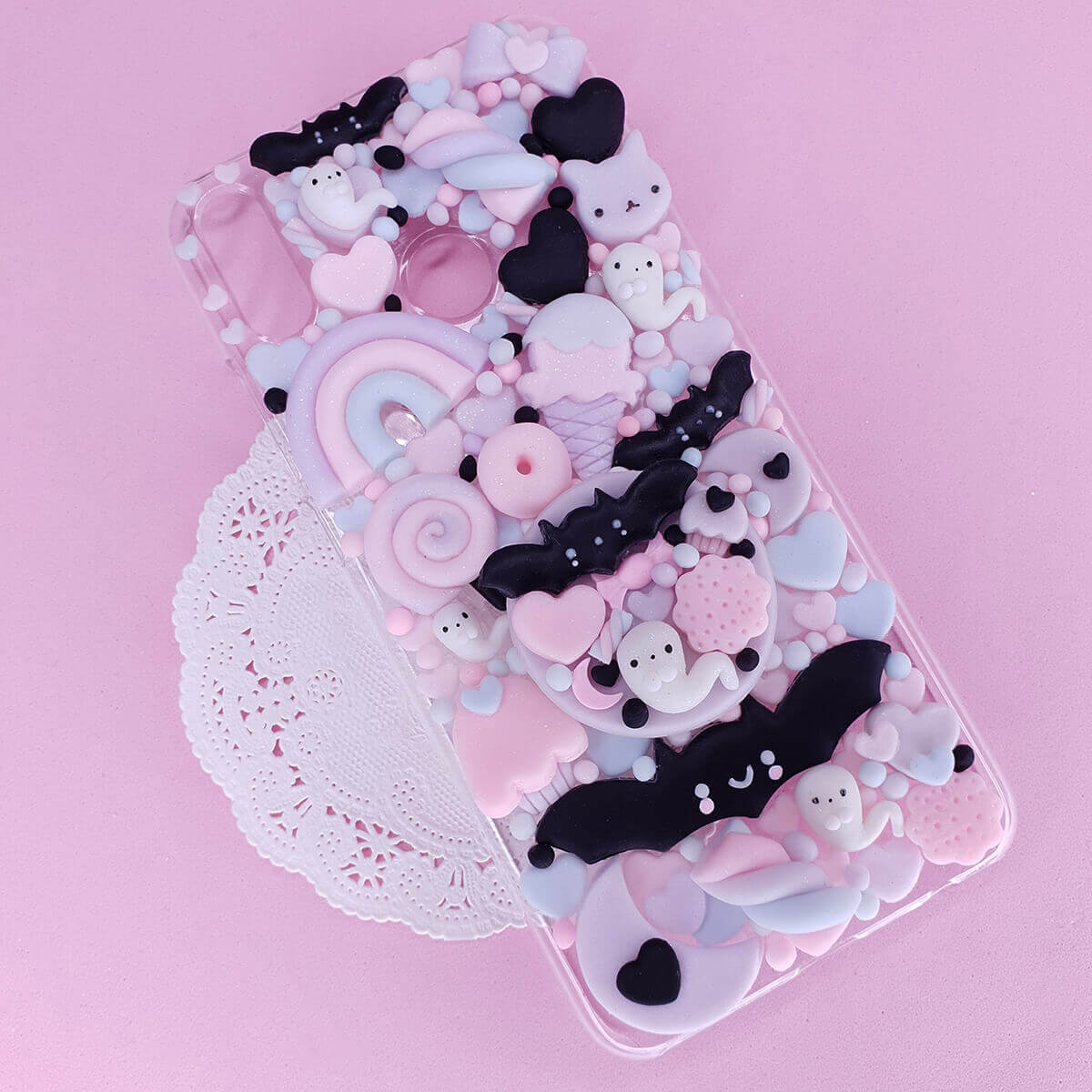 Handmade Pastel Goth Decoden case with black bats and pink ghosts on lavender 3D charms case, available for iPhone, Samsung, Oppo, and all smartphone models.