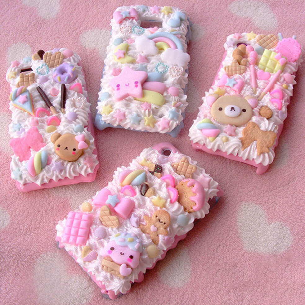 Handmade kawaii phone cases with whipped cream frosting and pastel candy charms
