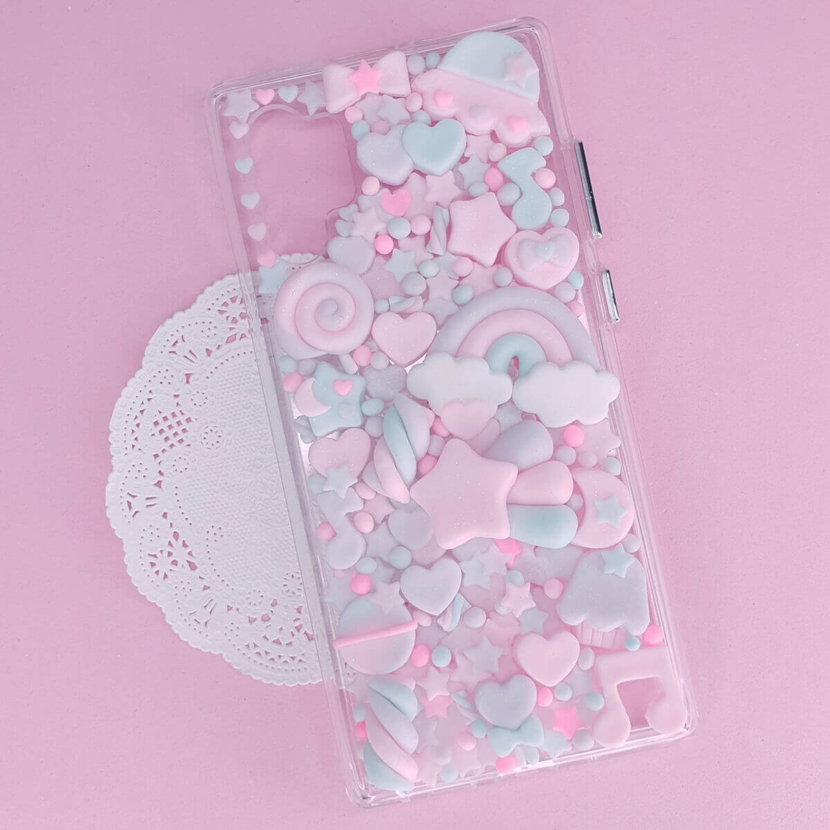 Pastel pink and blue kawaii decoden phone case with cute hearts and cloud decorations for smartphones.