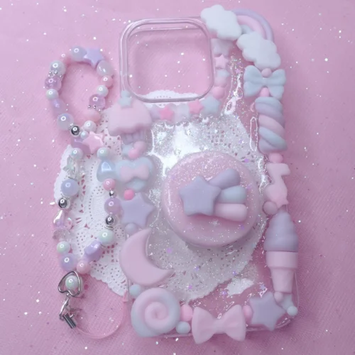 Pastel kawaii decoden phone case featuring charms of stars, bows, sweets, and a matching beaded wrist strap.